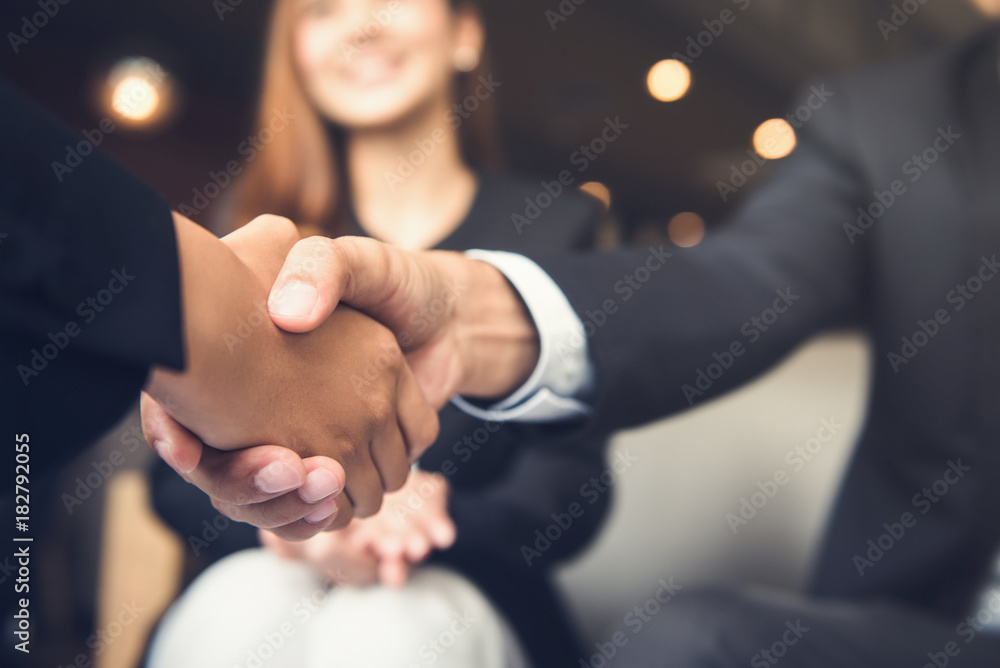 Businessmen shaking hands after meeting in a cafe