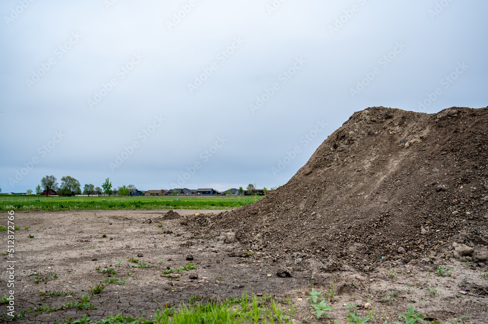 stockpiled topsoil at a residential development construction site.